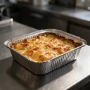 Grand ravier aluminium 2000 cc garni d'un gratin de pommes de terre doré pour quatre personnes